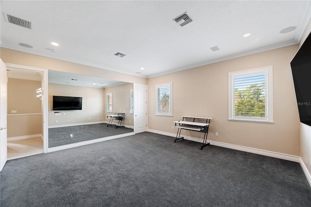 interior space featuring dark carpet, visible vents, and crown molding