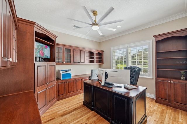 office area with visible vents, light wood finished floors, a ceiling fan, and crown molding