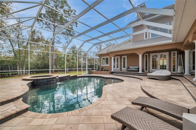 view of pool featuring a lanai, french doors, a patio area, a pool with connected hot tub, and outdoor lounge area