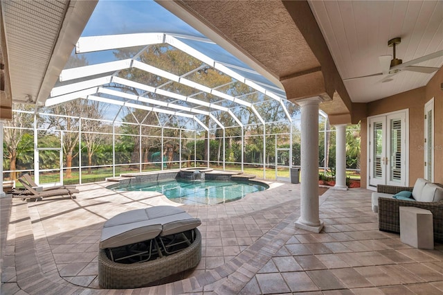 view of pool featuring a lanai, a pool with connected hot tub, a ceiling fan, and a patio