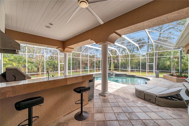 outdoor pool featuring area for grilling, a patio, grilling area, a lanai, and outdoor wet bar