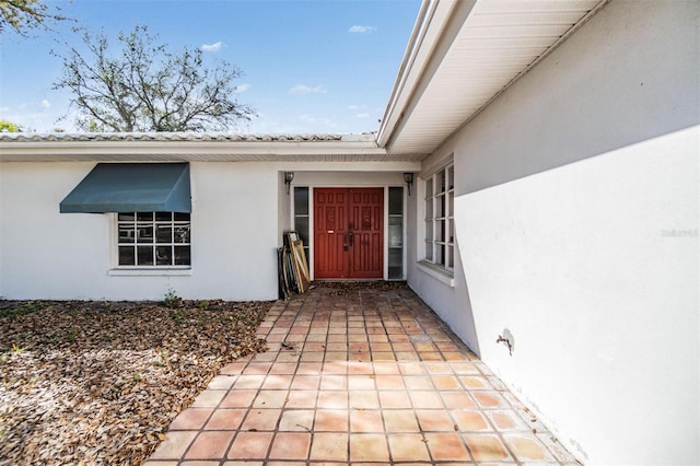 view of exterior entry featuring stucco siding