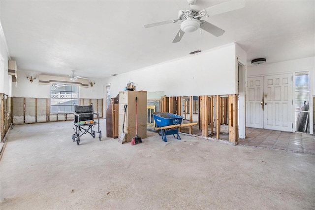 miscellaneous room with a ceiling fan, visible vents, and concrete floors