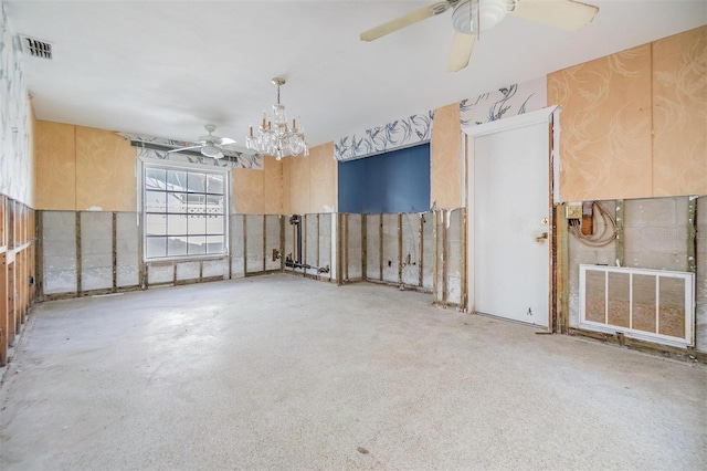 unfurnished room featuring ceiling fan with notable chandelier and visible vents