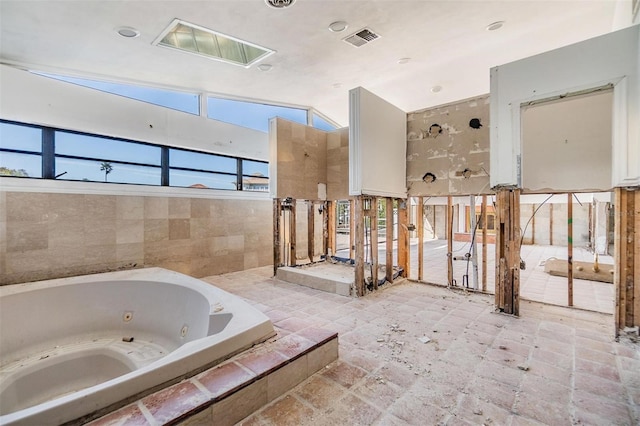 bathroom featuring visible vents and a tub with jets