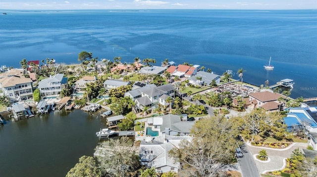 drone / aerial view featuring a residential view and a water view