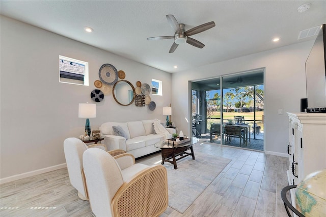 living room featuring light wood finished floors, recessed lighting, a ceiling fan, and baseboards