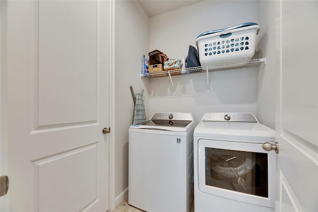 laundry room featuring baseboards, laundry area, and washer and dryer