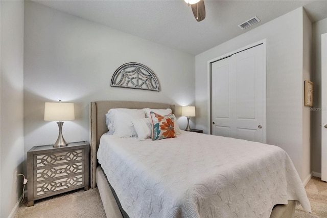 carpeted bedroom with a closet, visible vents, ceiling fan, and baseboards