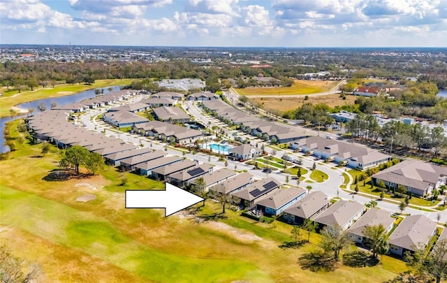 birds eye view of property featuring golf course view, a water view, and a residential view