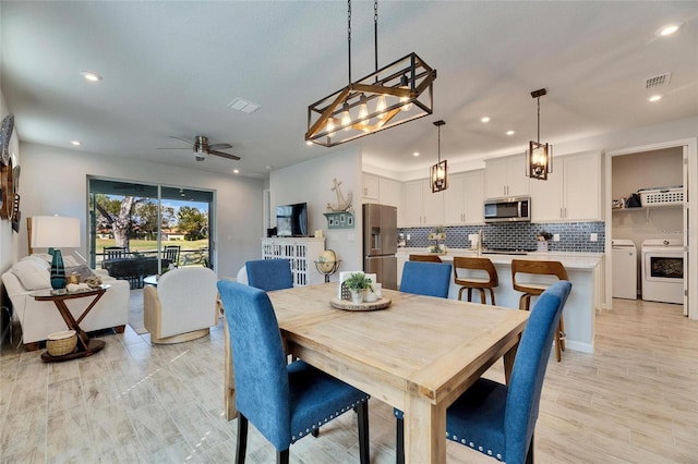 dining area featuring recessed lighting, visible vents, a ceiling fan, and washing machine and clothes dryer