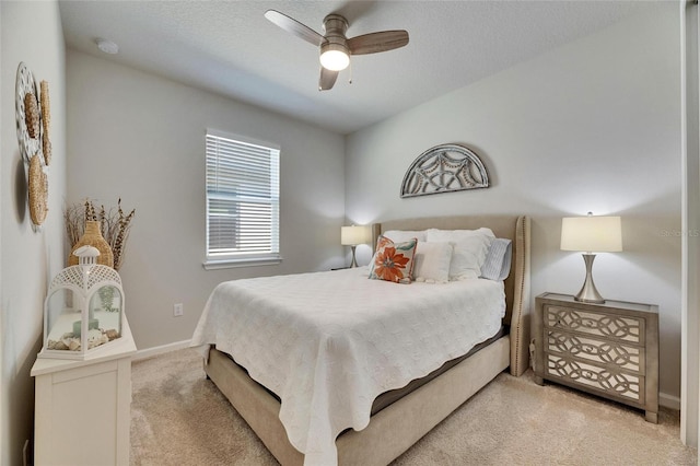 bedroom featuring baseboards, ceiling fan, and light colored carpet