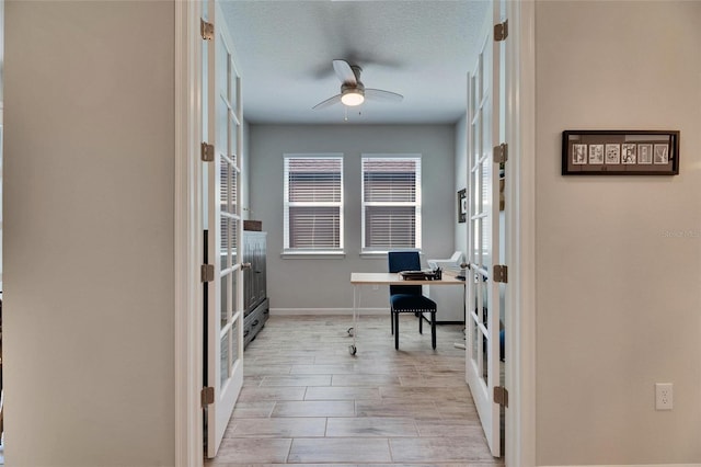 office with baseboards, a ceiling fan, wood tiled floor, a textured ceiling, and french doors