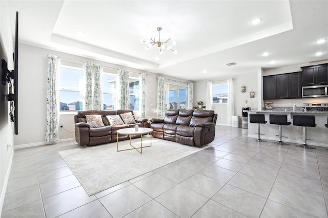 9119 Forge Breeze Loop, Wesley Chapel, FL 33545 - living area with a raised ceiling, light tile patterned flooring, a chandelier, recessed lighting, and baseboards