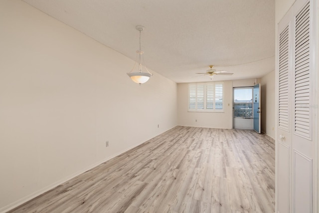 empty room featuring a ceiling fan and light wood finished floors