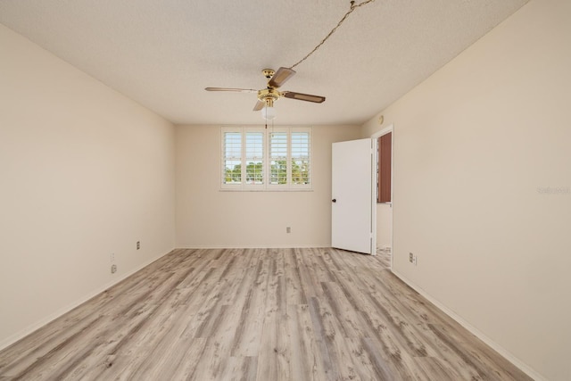 unfurnished room featuring light wood-style flooring, baseboards, ceiling fan, and a textured ceiling