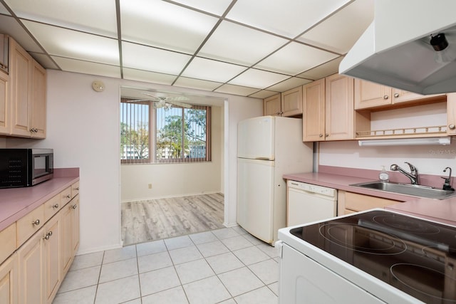 4715 Bay St NE Unit 323, Saint Petersburg, FL 33703 - kitchen featuring white appliances, light tile patterned floors, a ceiling fan, a sink, and under cabinet range hood