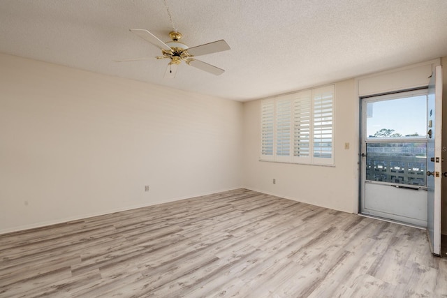 4715 Bay St NE Unit 323, Saint Petersburg, FL 33703 - unfurnished room with a textured ceiling, light wood-style flooring, and ceiling fan