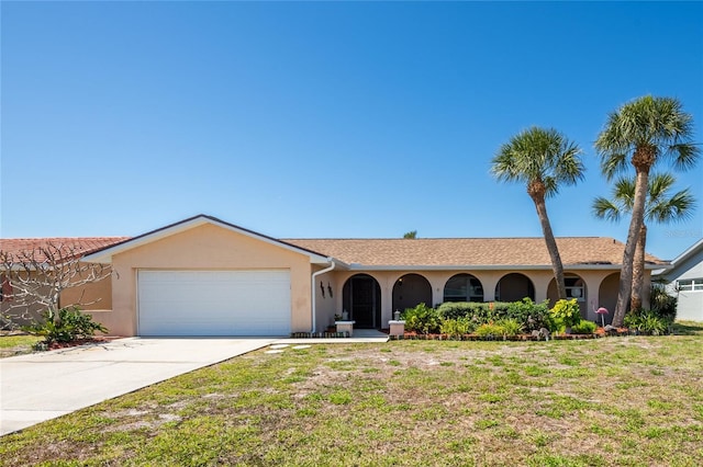 single story home with stucco siding, a garage, concrete driveway, and a front lawn