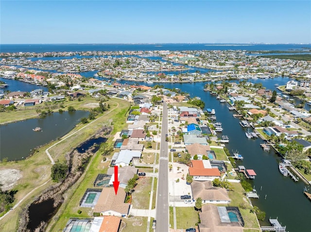 drone / aerial view featuring a residential view and a water view