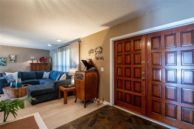 entryway with a textured ceiling and wood finished floors