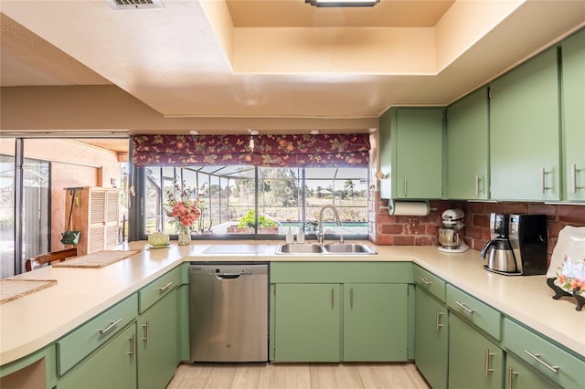 kitchen with visible vents, dishwasher, light countertops, light wood-style floors, and a sink