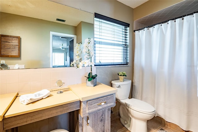 bathroom with tile patterned flooring, visible vents, toilet, decorative backsplash, and vanity