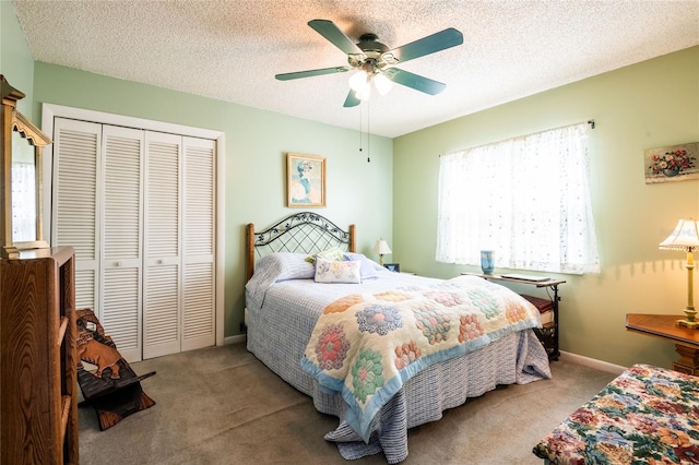 carpeted bedroom featuring a closet, ceiling fan, a textured ceiling, and baseboards