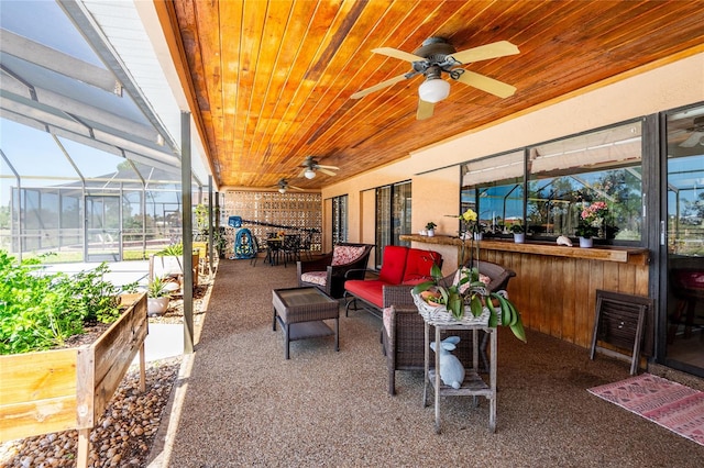 view of patio / terrace featuring glass enclosure, outdoor lounge area, outdoor dining area, a ceiling fan, and a vegetable garden