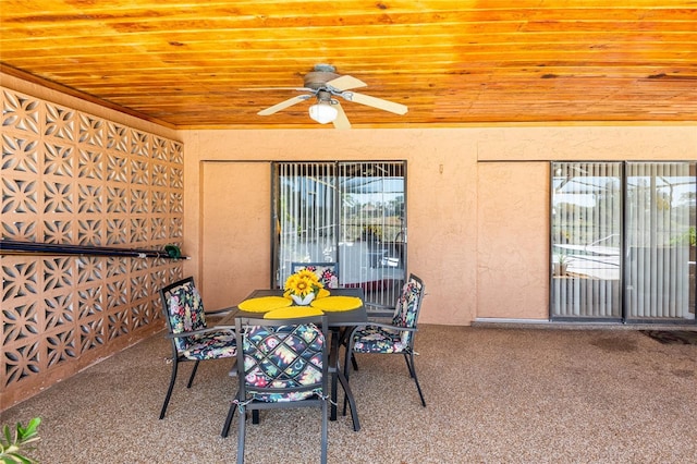 carpeted dining area featuring plenty of natural light, wood ceiling, and ceiling fan