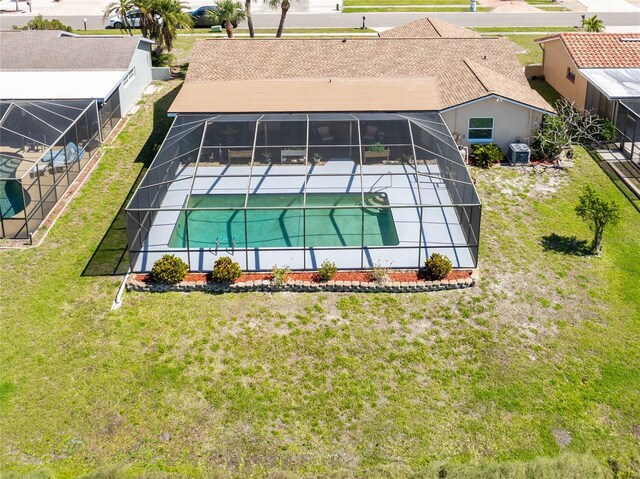 exterior space with fence, a lawn, a lanai, and a patio area