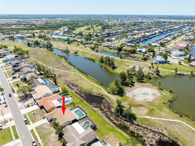 drone / aerial view featuring a residential view and a water view