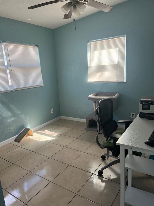 home office with baseboards, a ceiling fan, and light tile patterned flooring