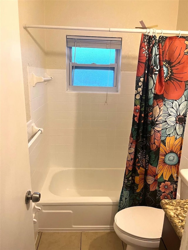 bathroom with toilet, tile patterned flooring, shower / bathtub combination with curtain, and vanity