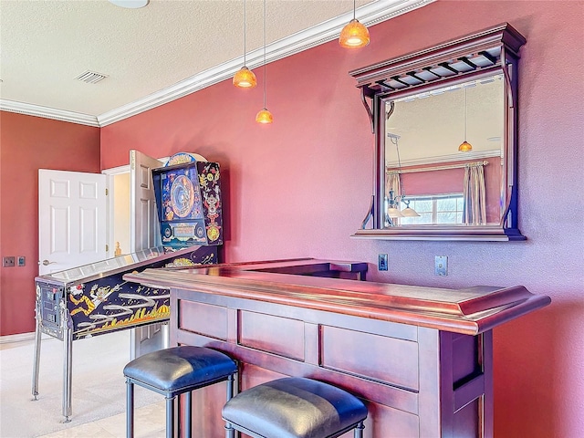 bar featuring ornamental molding, hanging light fixtures, a bar, and visible vents