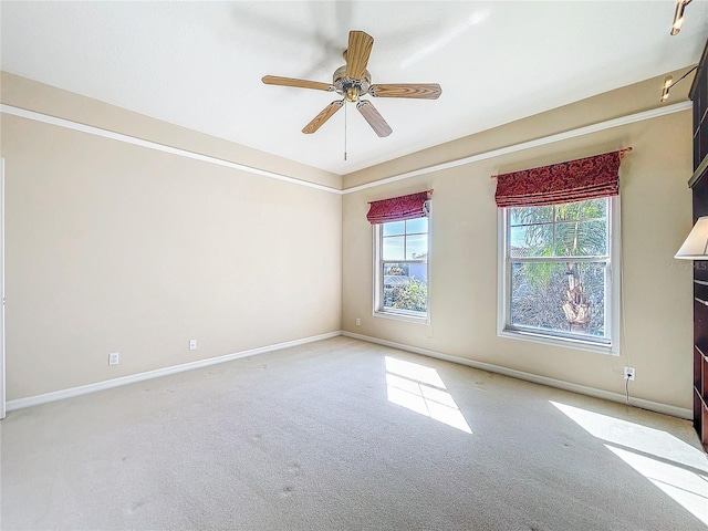 unfurnished room featuring ceiling fan, carpet flooring, and baseboards