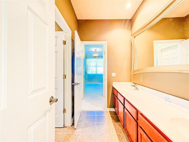 bathroom featuring double vanity, a sink, and tile patterned floors