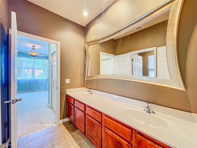 bathroom with double vanity, visible vents, a sink, and tile patterned floors