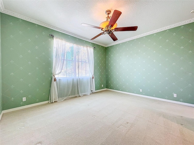 empty room with wallpapered walls, a textured ceiling, and carpet flooring