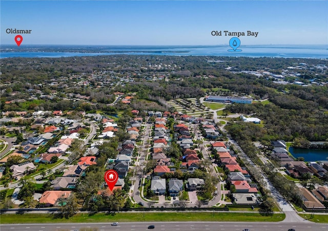 drone / aerial view with a water view and a residential view