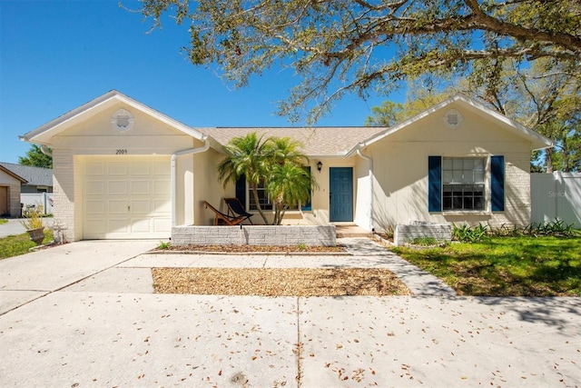 single story home featuring concrete driveway, fence, brick siding, and a garage