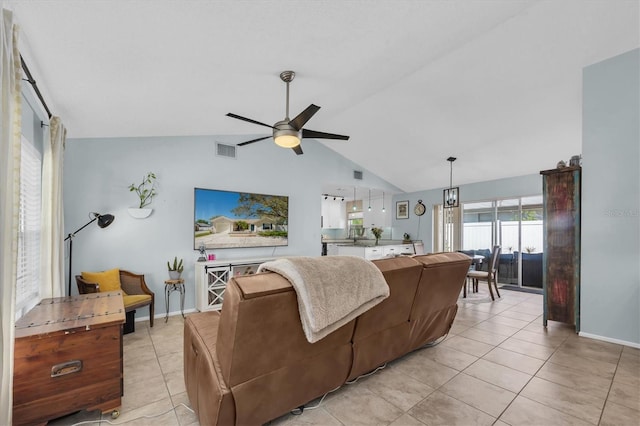 living area featuring visible vents, baseboards, ceiling fan, lofted ceiling, and light tile patterned floors