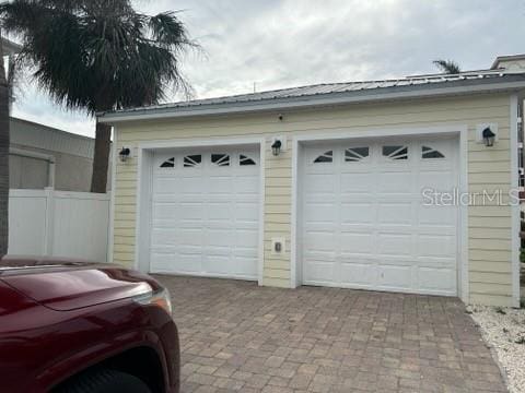 garage featuring decorative driveway