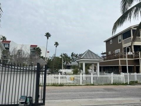 view of gate with a fenced front yard