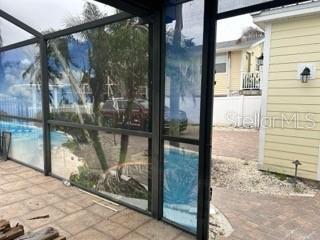 doorway to outside featuring a sunroom and expansive windows