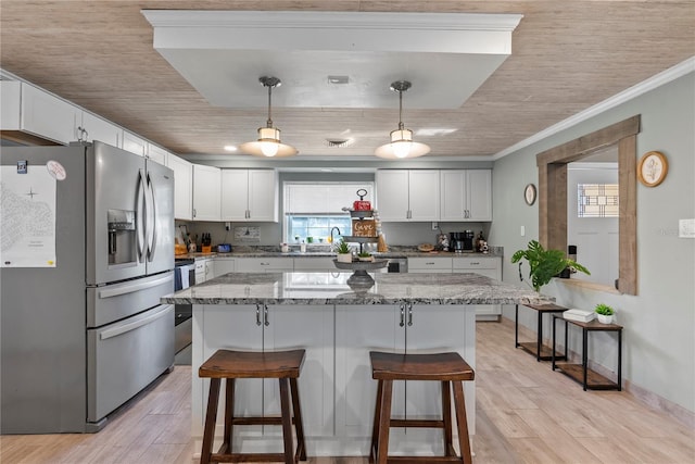 kitchen featuring light wood-style floors, a kitchen bar, white cabinetry, and stainless steel refrigerator with ice dispenser