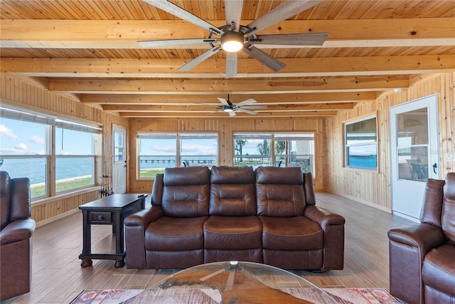 living room with beamed ceiling, wood finished floors, and baseboards