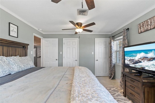 bedroom with ornamental molding, visible vents, light wood finished floors, and a ceiling fan