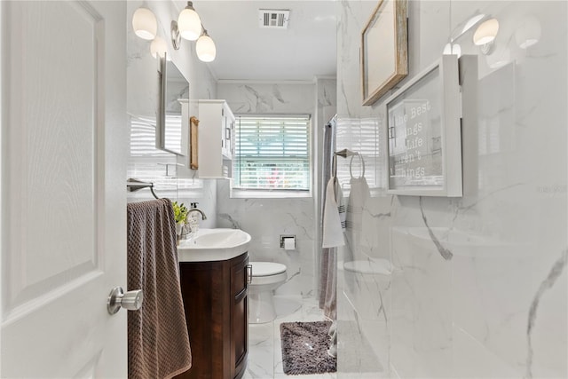 full bath with a marble finish shower, visible vents, toilet, marble finish floor, and vanity