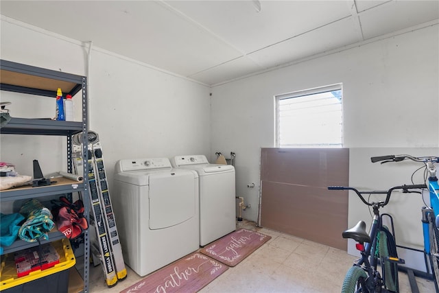 clothes washing area featuring laundry area and washer and clothes dryer